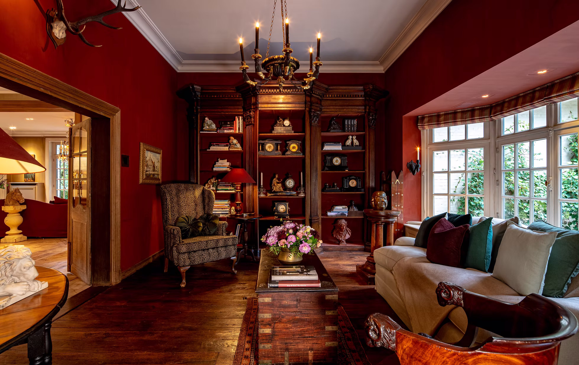 A richly appointed red interior staged by Whisper Auctions