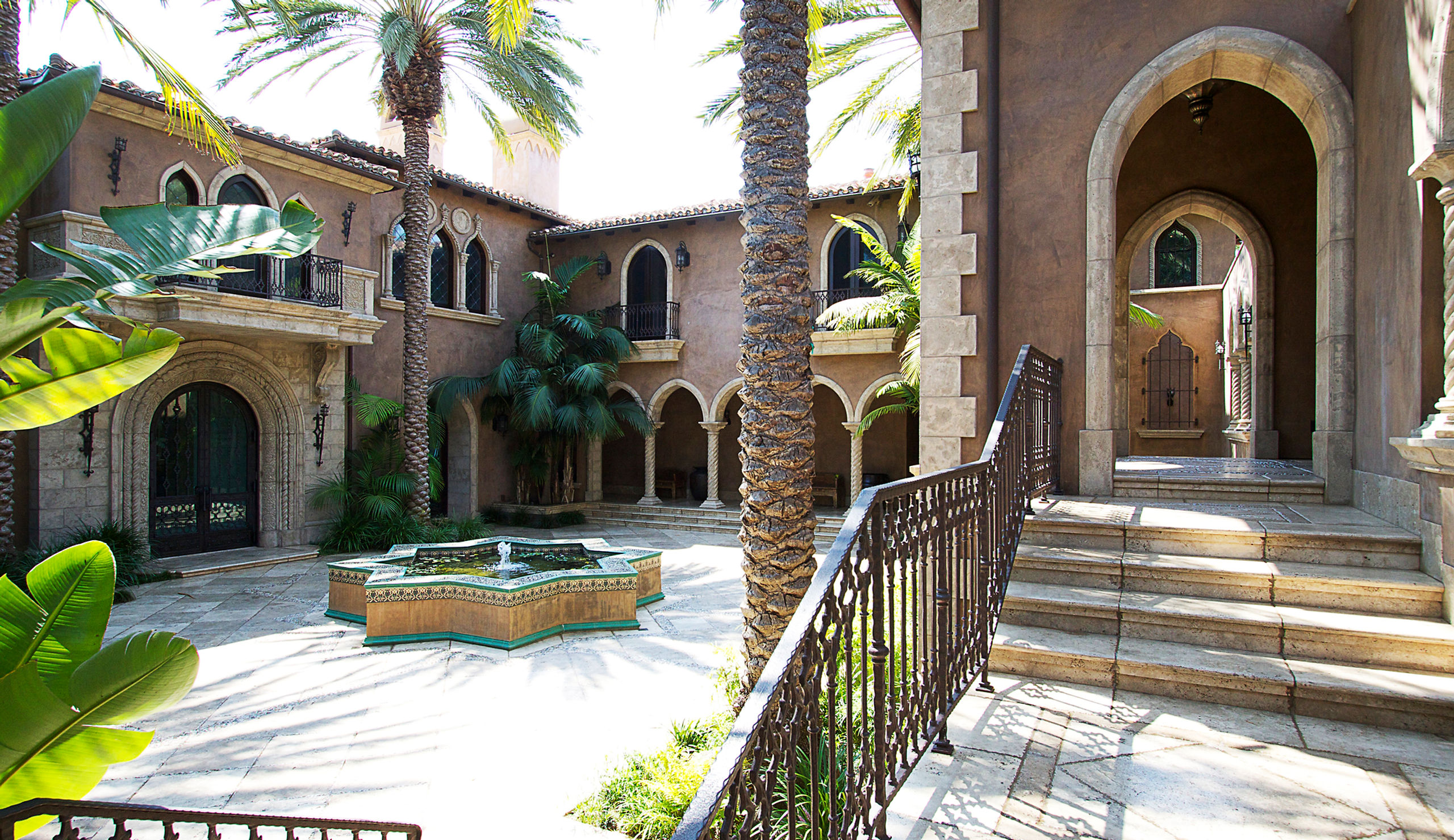 Exotic estate exterior with palm trees