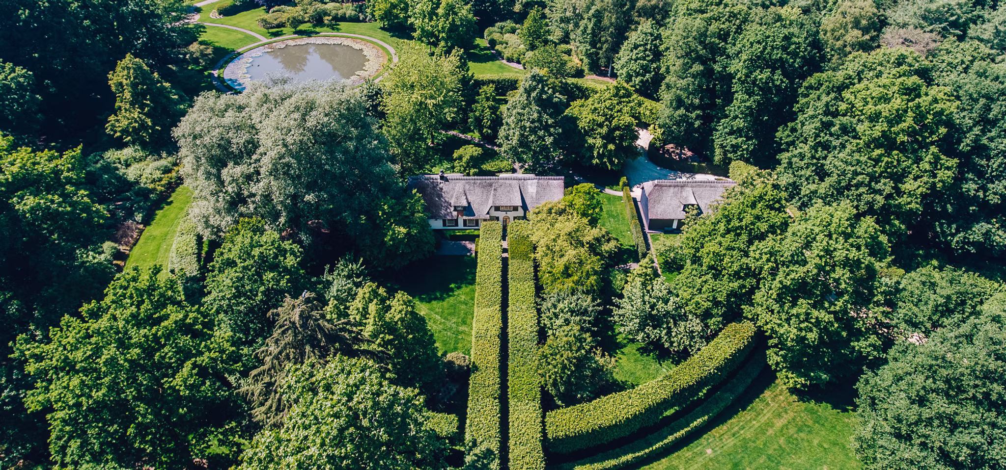 Aerial view of a luxury estate surrounded by gardens.